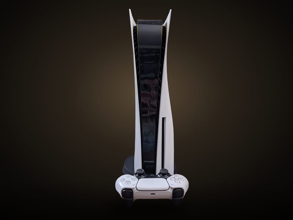 PlayStation 5 console standing upright with a DualSense controller in front