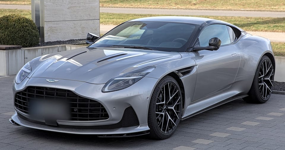 Aston Martin DB12 from the front left, showing the bonnet vents and grille
